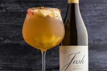 Amber sangria cocktail with floating pieces of apple, pear, and fig. Fall cocktail photography for Speak Easy Podcast.